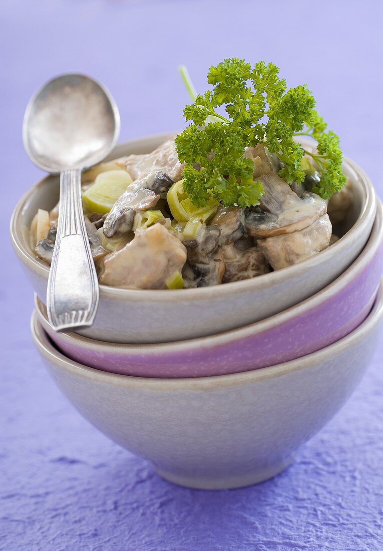 Blanquette of veal with leeks and mushrooms in a bowl