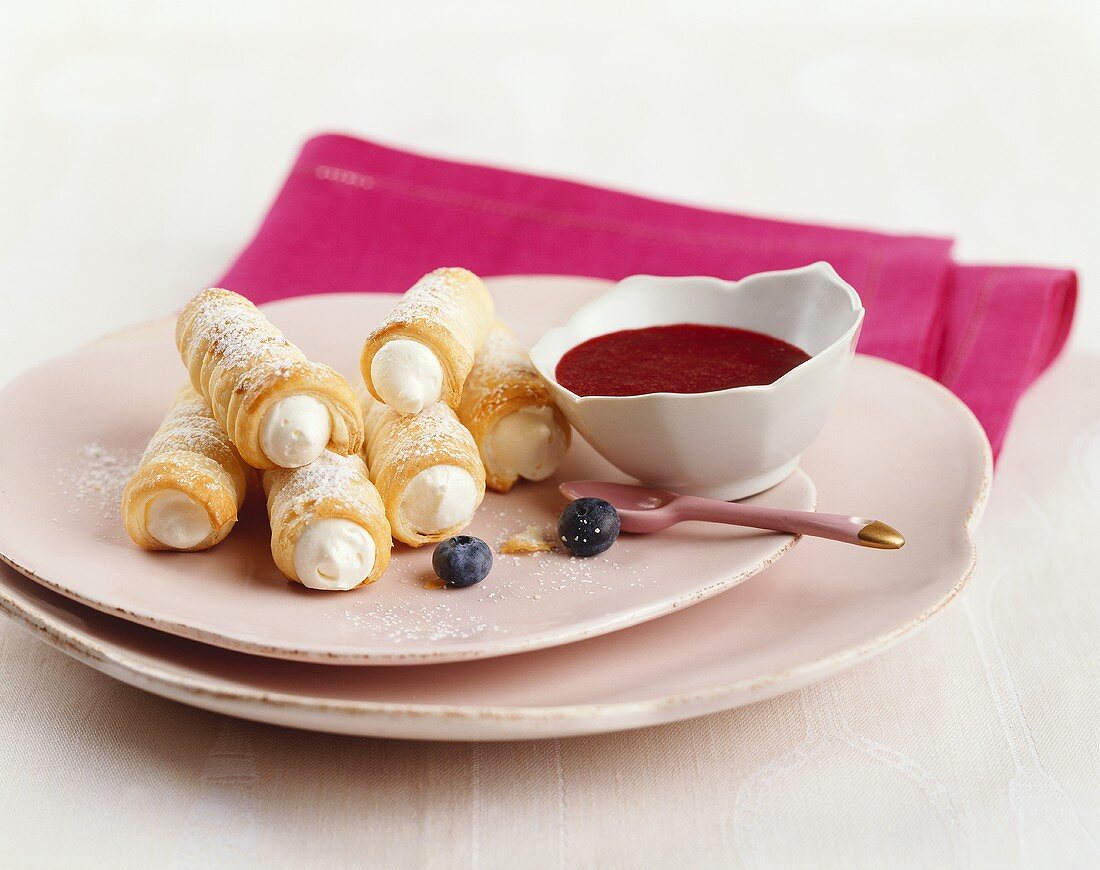Quark-filled puff pastry rolls with raspberry sauce