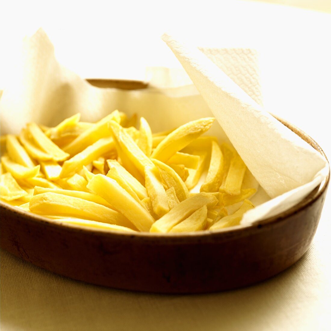 Home-made chips on kitchen paper