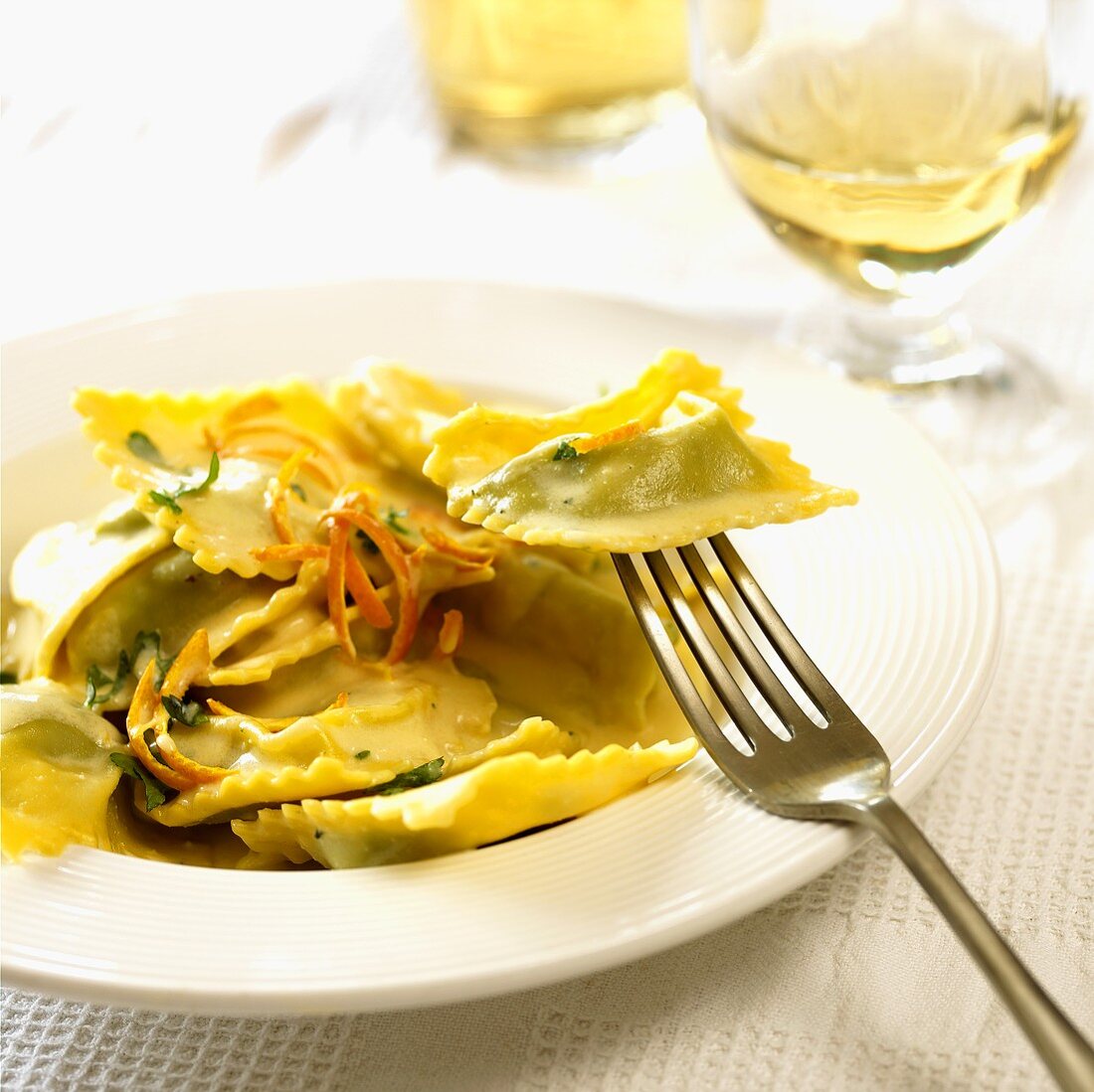 Herb ravioli in orange sauce