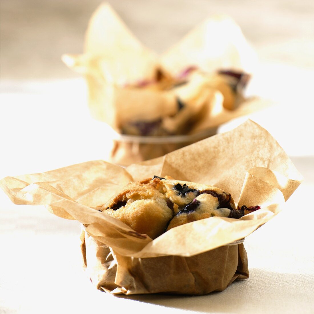 Small blueberry cakes baked in baking parchment