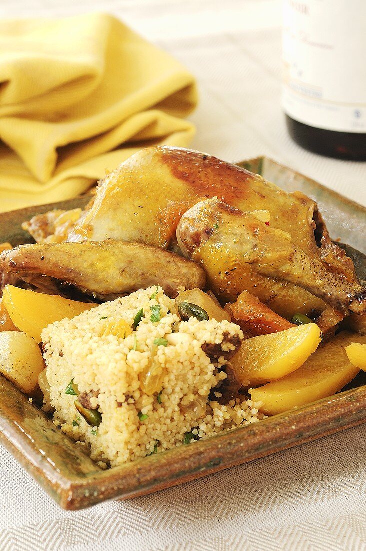 Roast pigeon and couscous with dried fruit