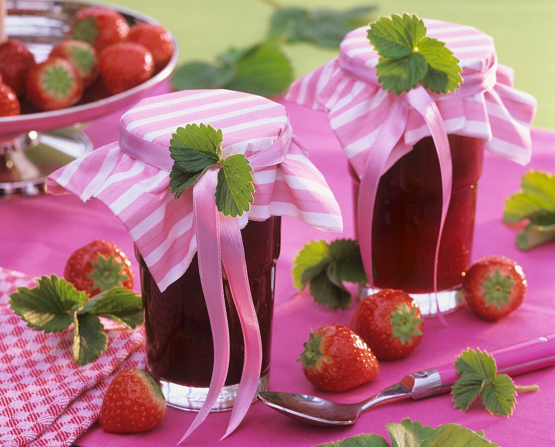 Two jars of strawberry jam with gift ribbons