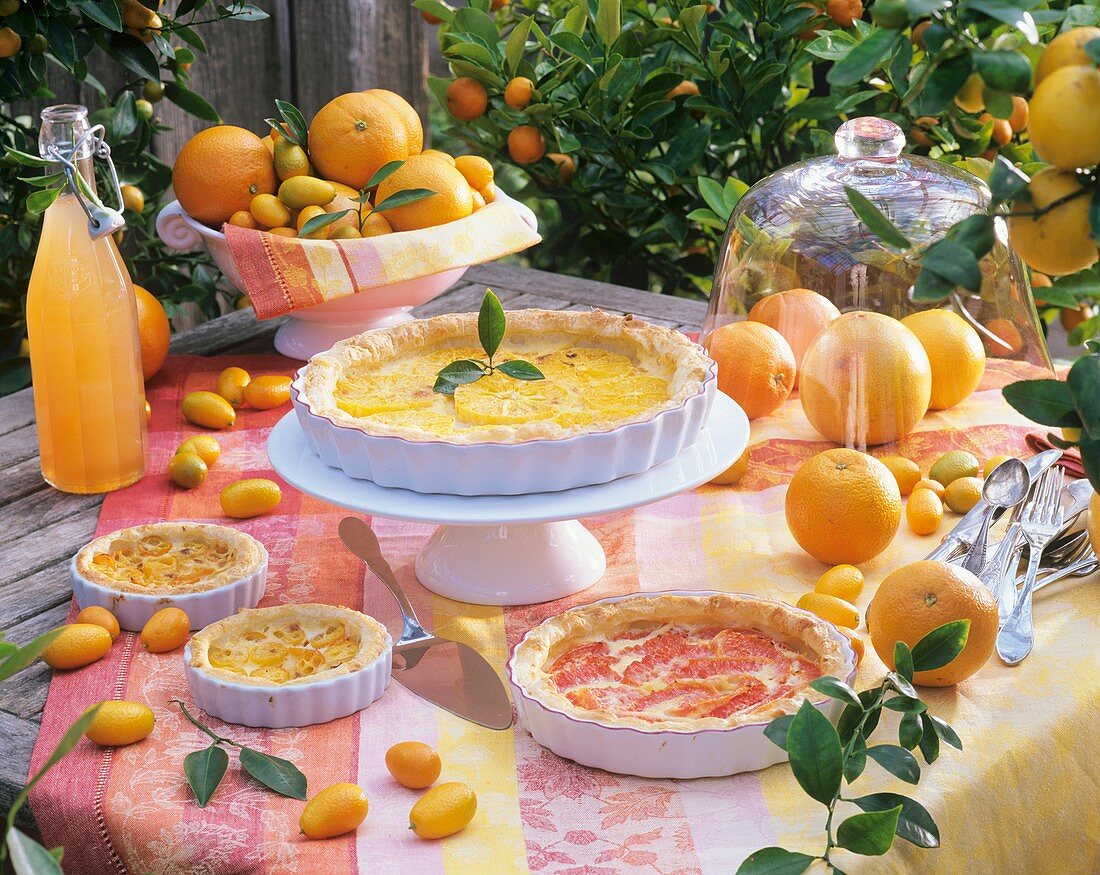 Several puff pastry tarts with citrus fruit fillings, outdoors