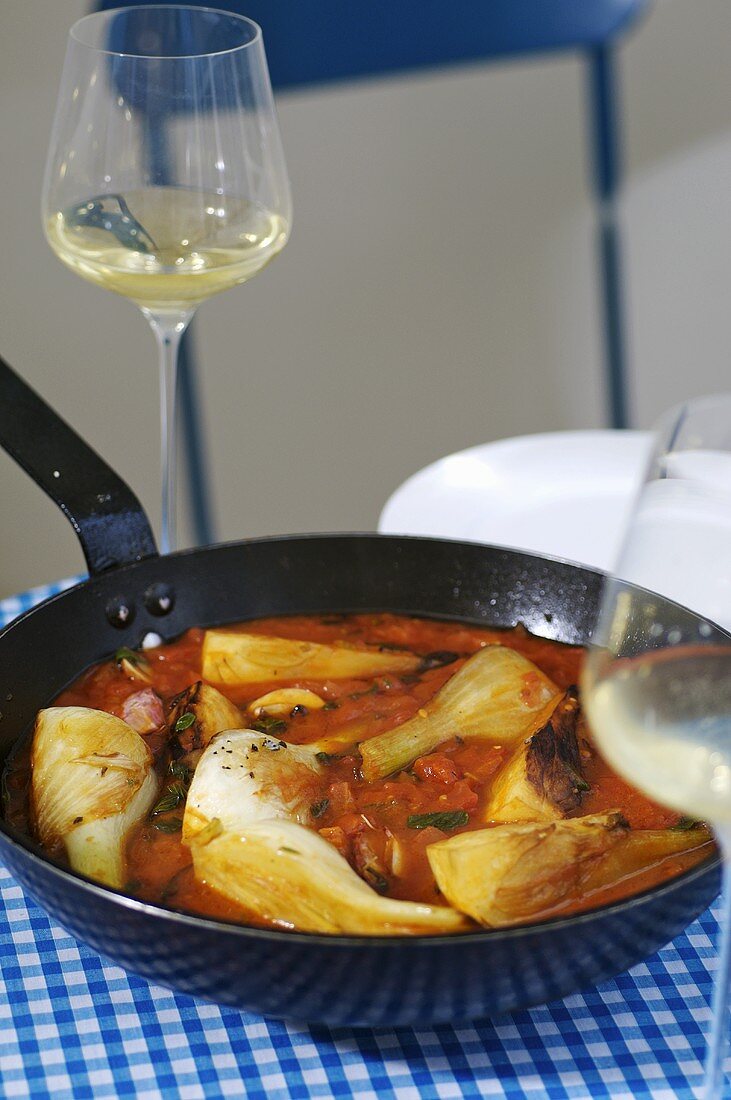 Haddock and fennel in wine sauce in a frying pan