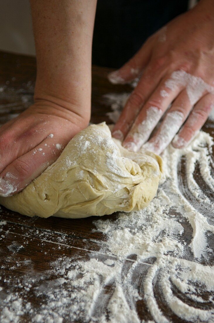 Kneading yeast dough on a floured work surface