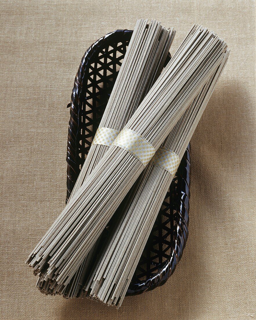 Soba noodles, in bundles on a wicker basket