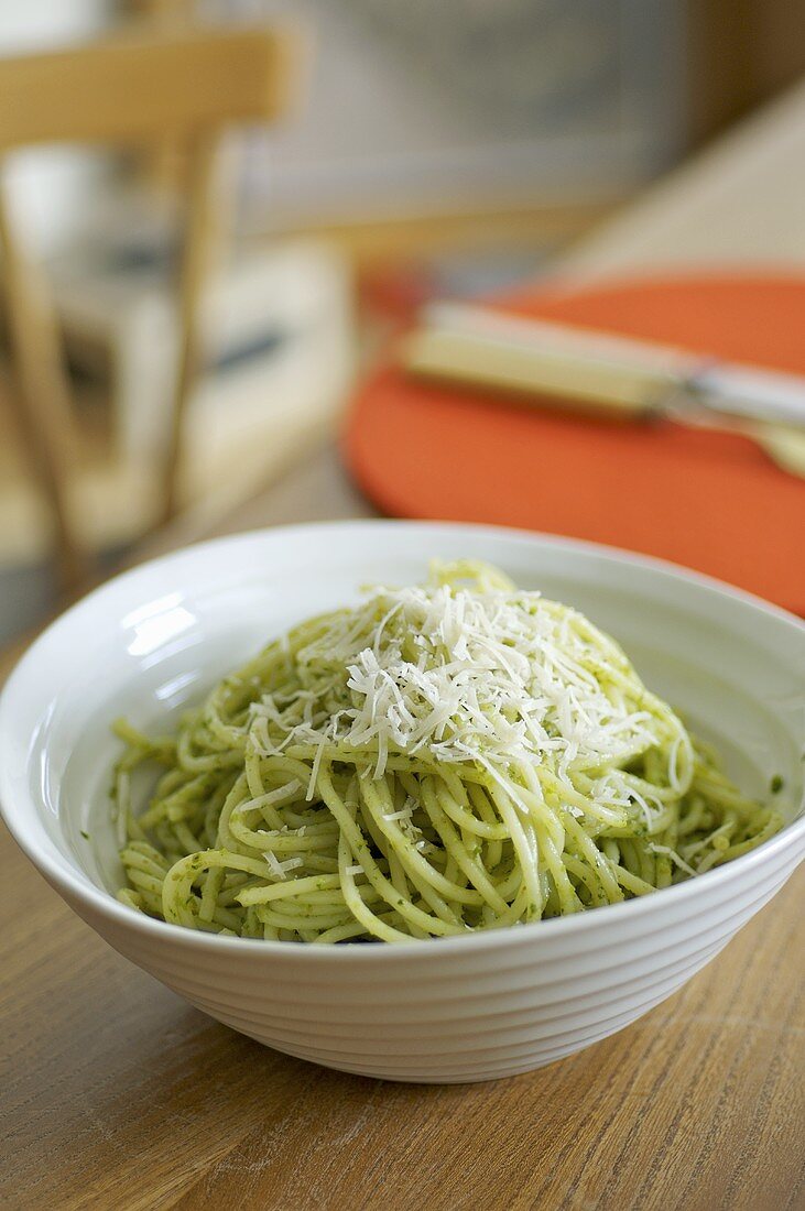 Spaghetti with herb & caper sauce and Parmesan in dish