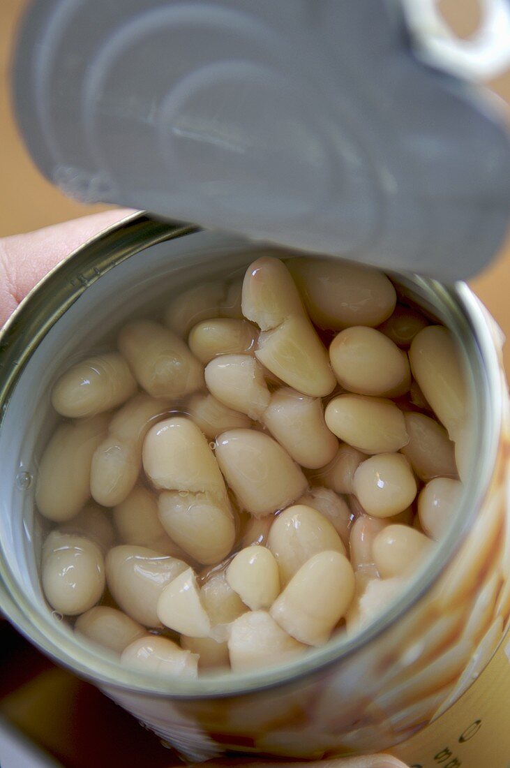 An opened tin of white beans