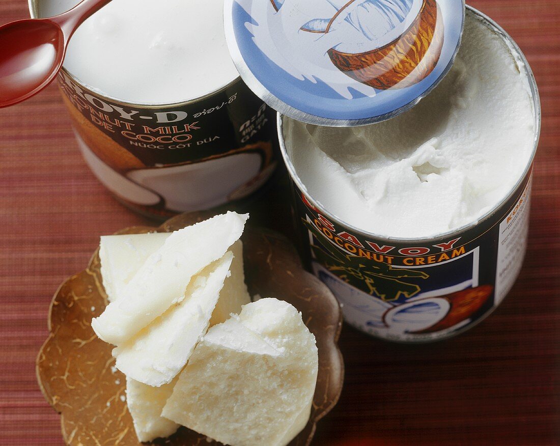 Coconut milk and coconut cream in tins and in a small dish