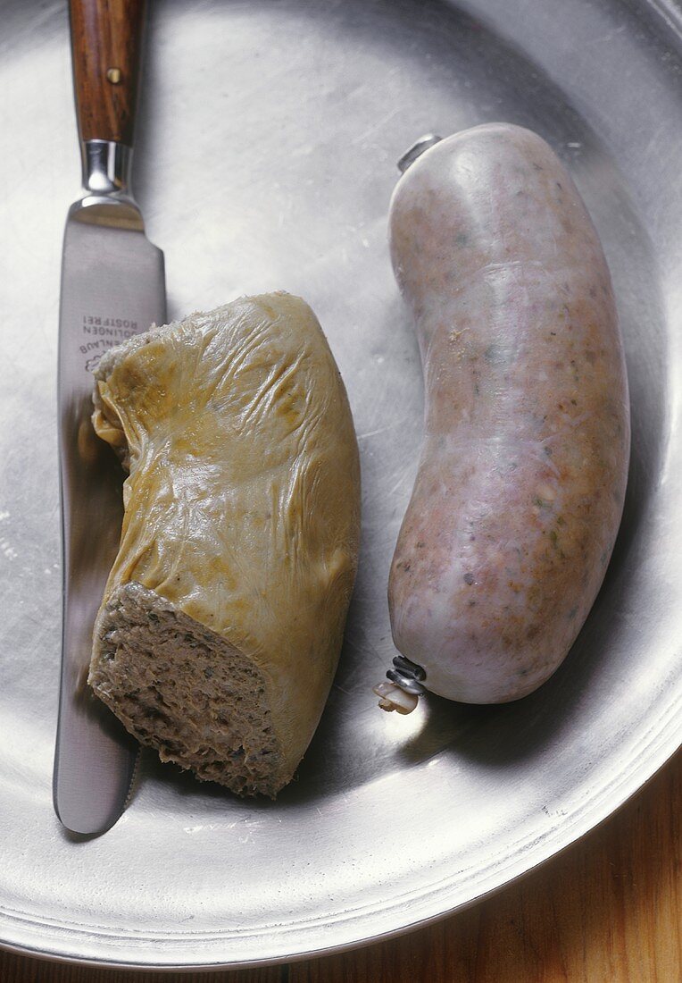 Liver sausage and knife on a pewter plate