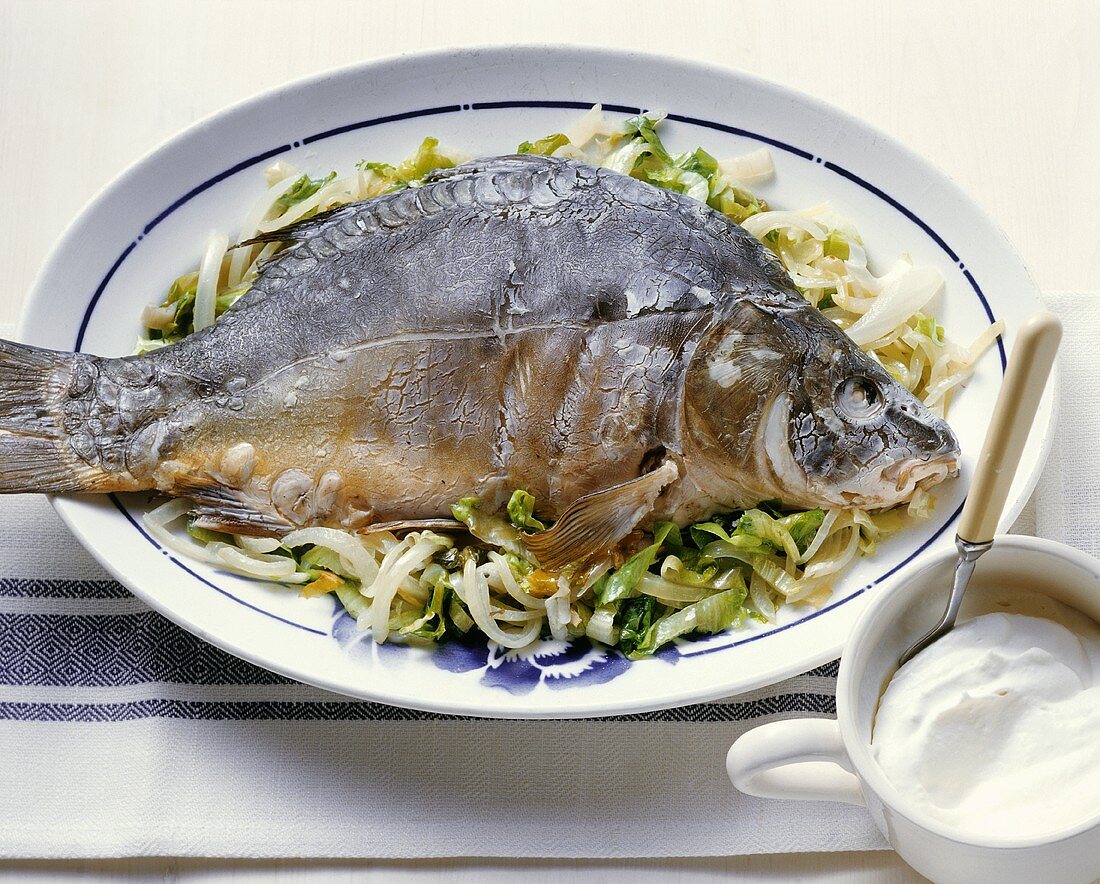 A whole carp cooked 'au bleu' on endive with creamed horseradish