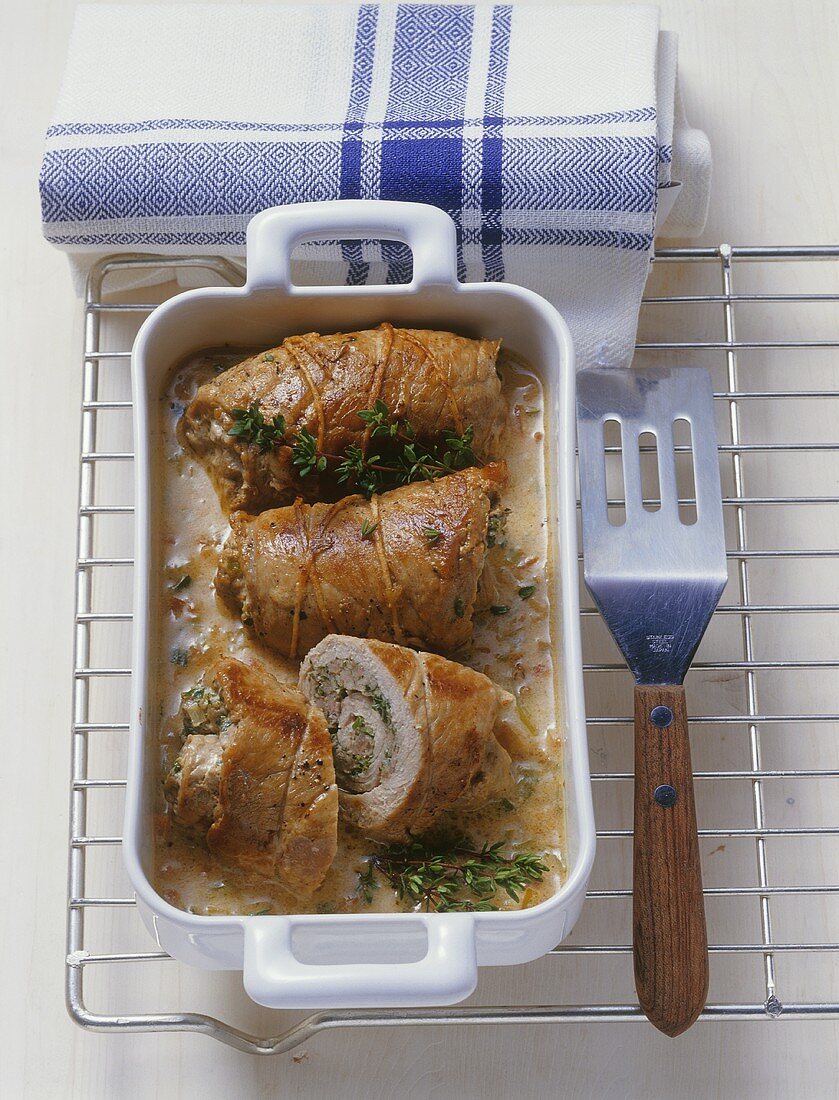 Veal roulades with herbs & sausagemeat stuffing in roasting dish