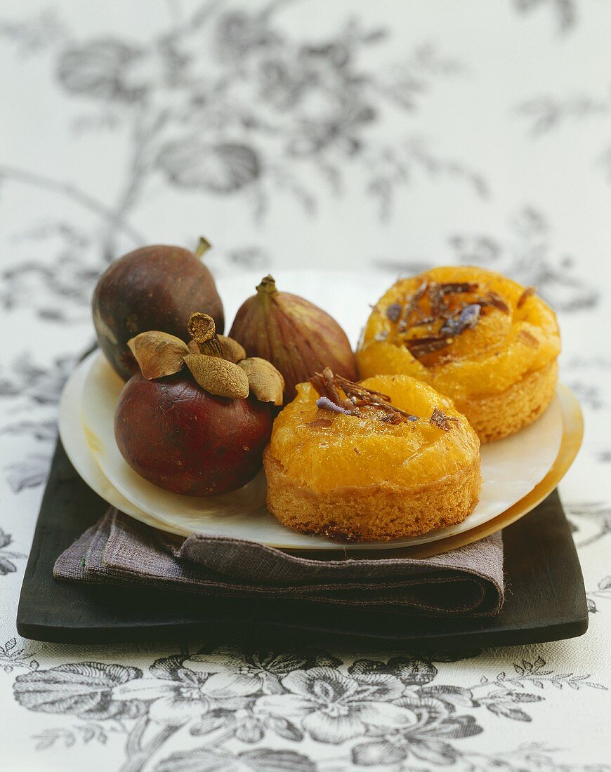 Two small chocolate orange cakes with figs on a plate
