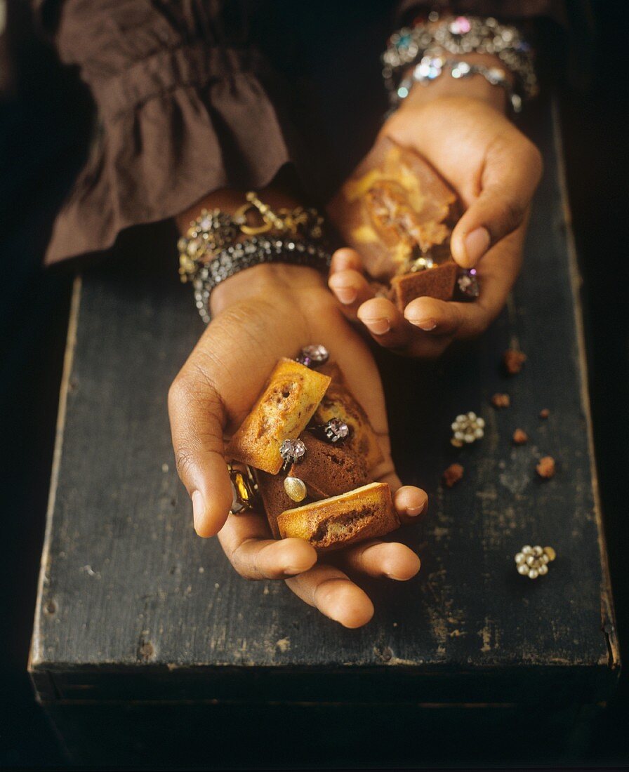 Woman holding financiers and jewellery in her hands