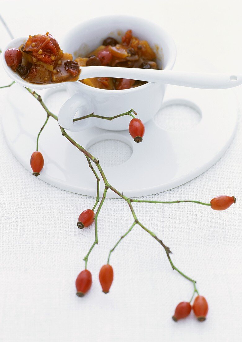 Rose hip and quince chutney in a cup with spoon
