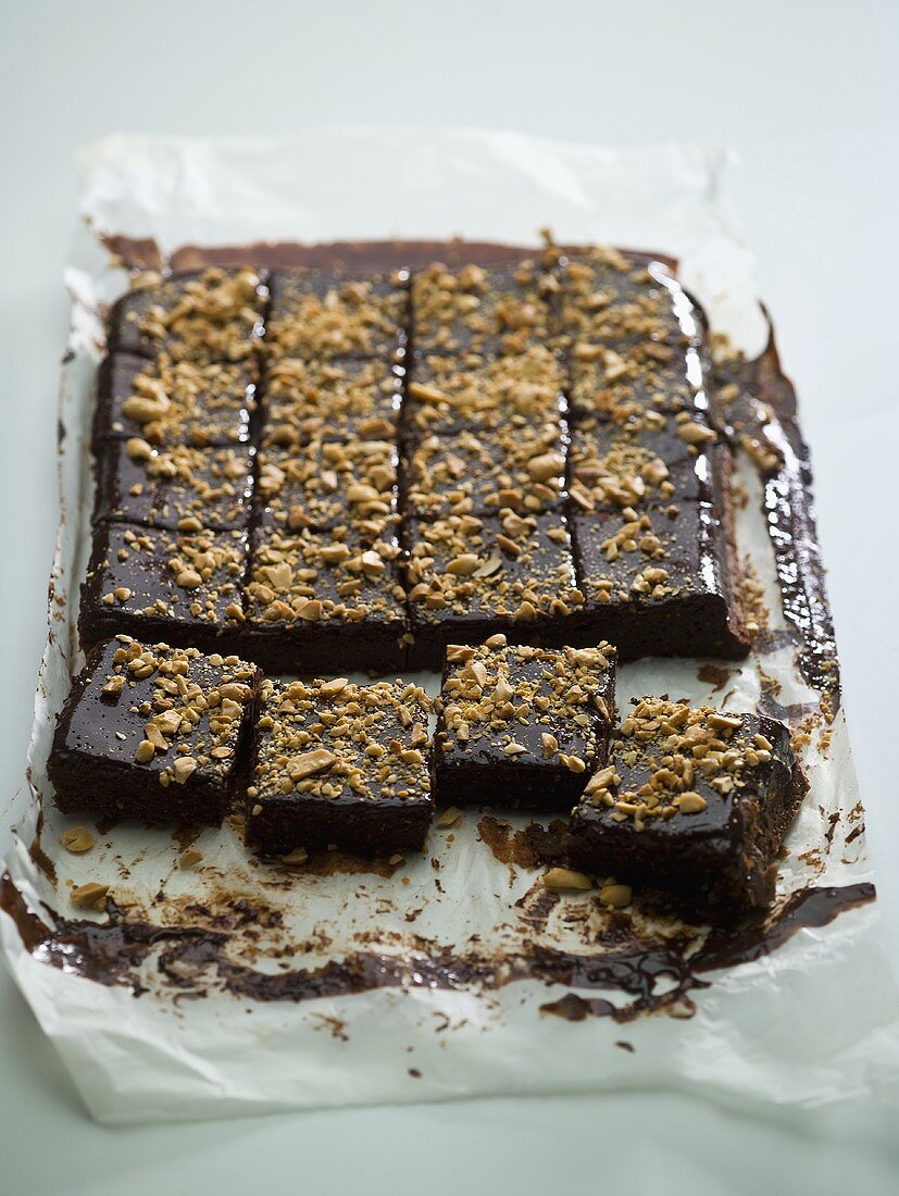 Chocolate tray-bake, cut into squares, on baking parchment