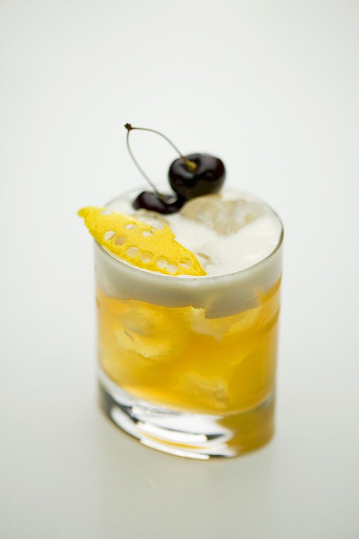 A lemon cocktail with cherries