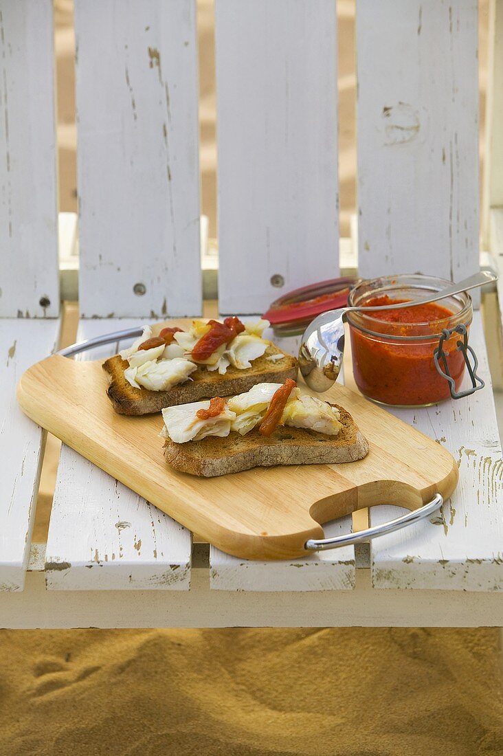 Two slices of toasted bread topped with cod & pepper cream