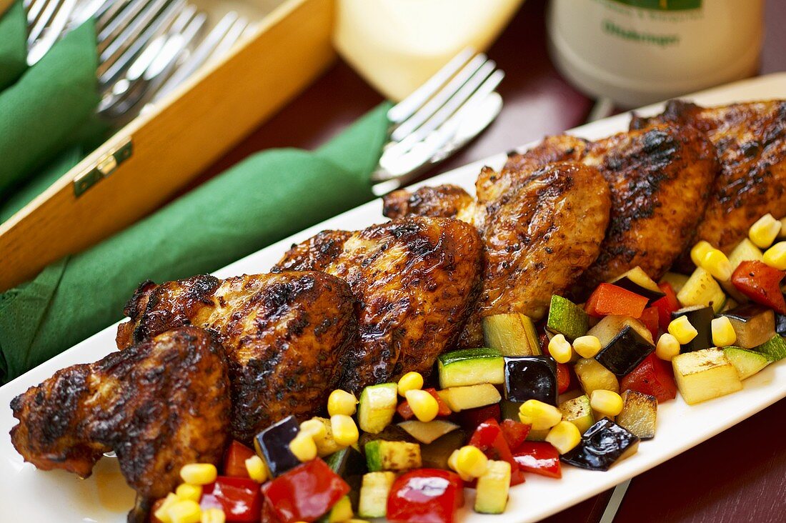 Grilled chicken wings with vegetables on a platter