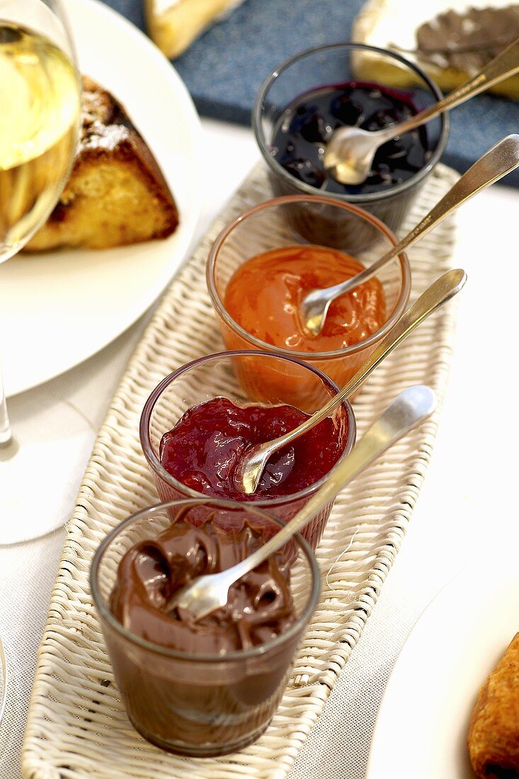 Various jams and hazelnut chocolate spread for breakfast