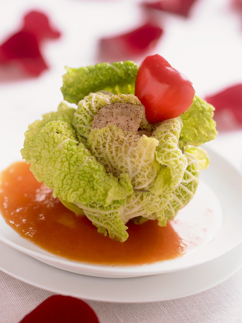 Savoy cabbage leaves stuffed with goose liver on tomato sauce