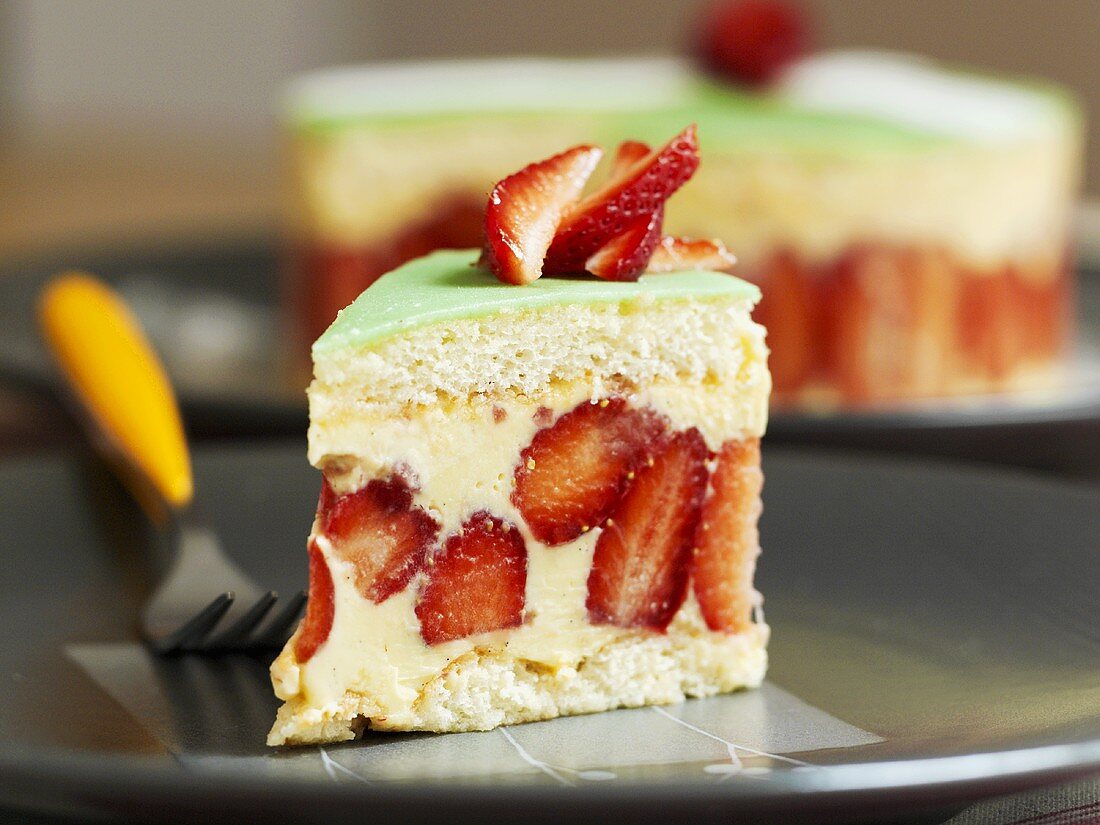 Piece of strawberry sponge cake with vanilla cream & marzipan
