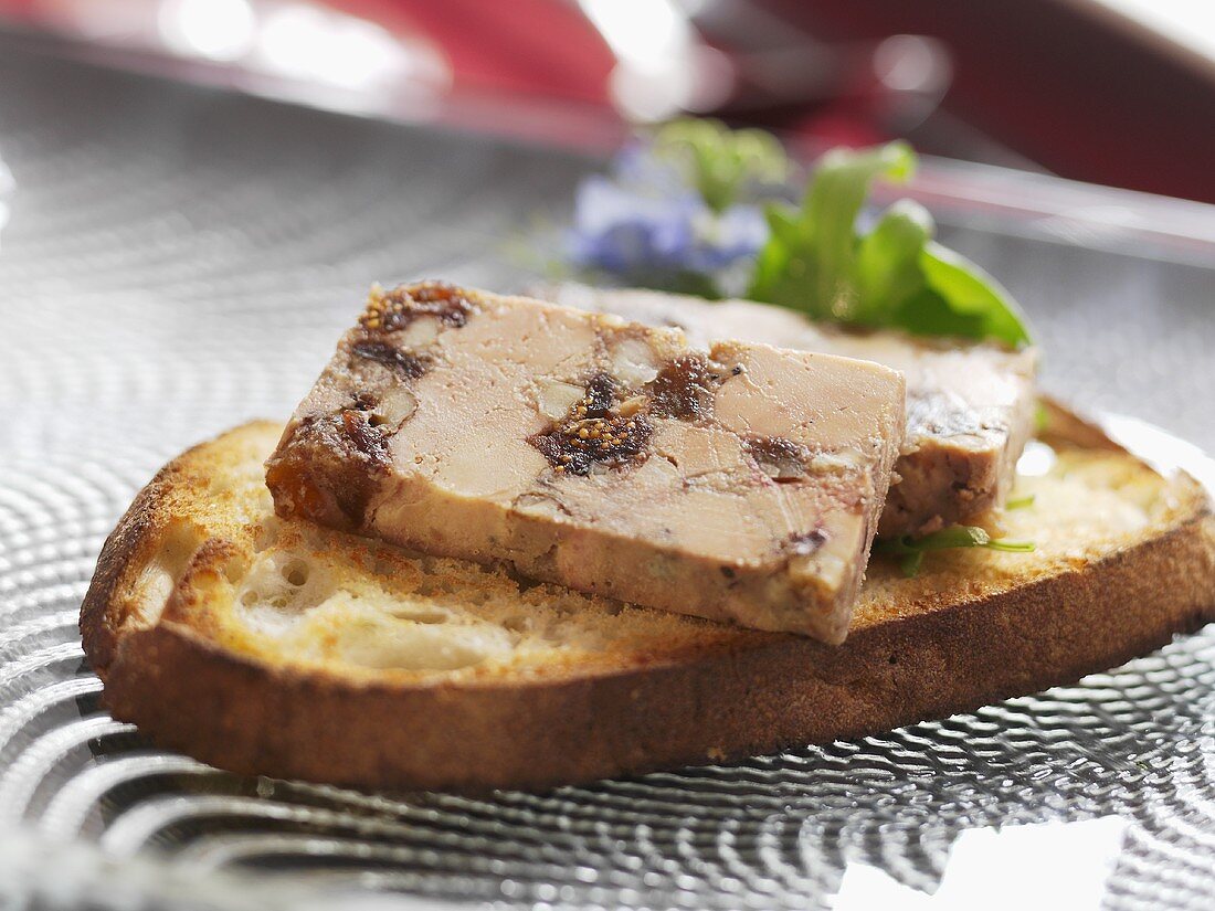 Goose liver with dried fruit on toasted white bread