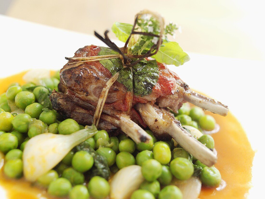 Fried lamb chop parcels with herbs on peas