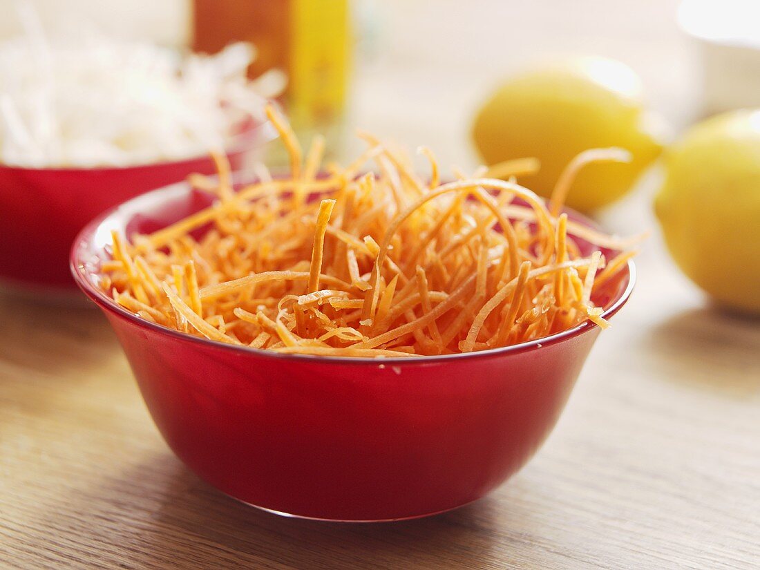 Grated carrots in a glass bowl