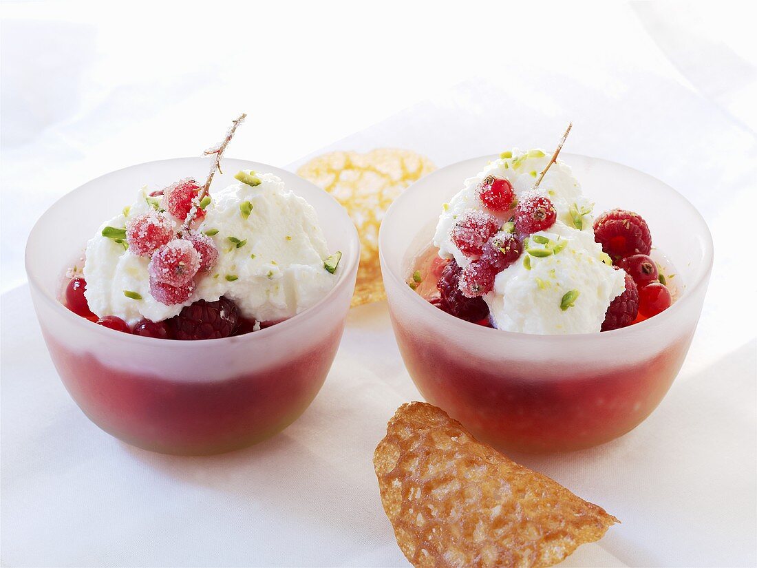 Red fruit compote with fresh goat's cheese in two glass bowls