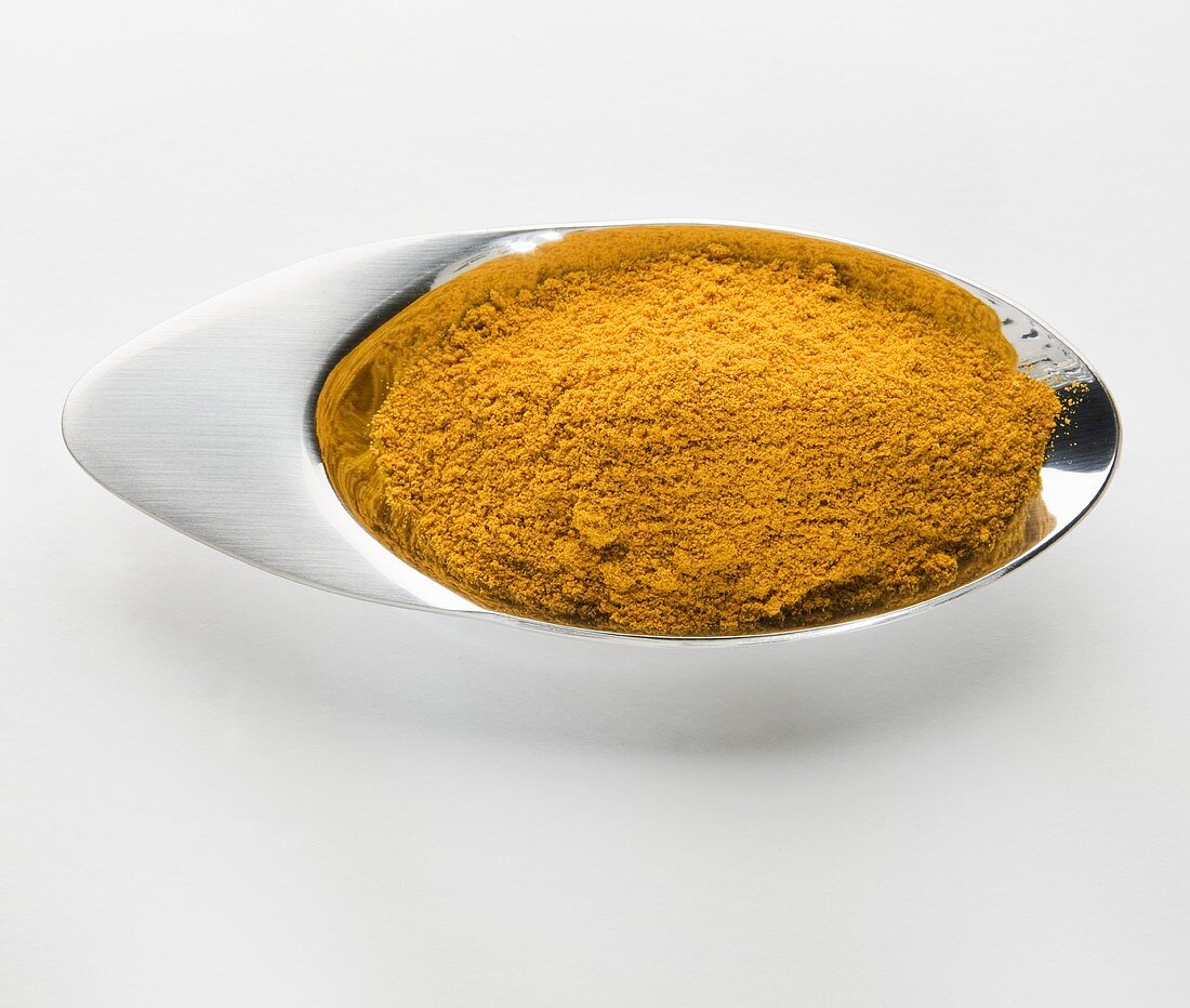 Ground turmeric in a small metal dish