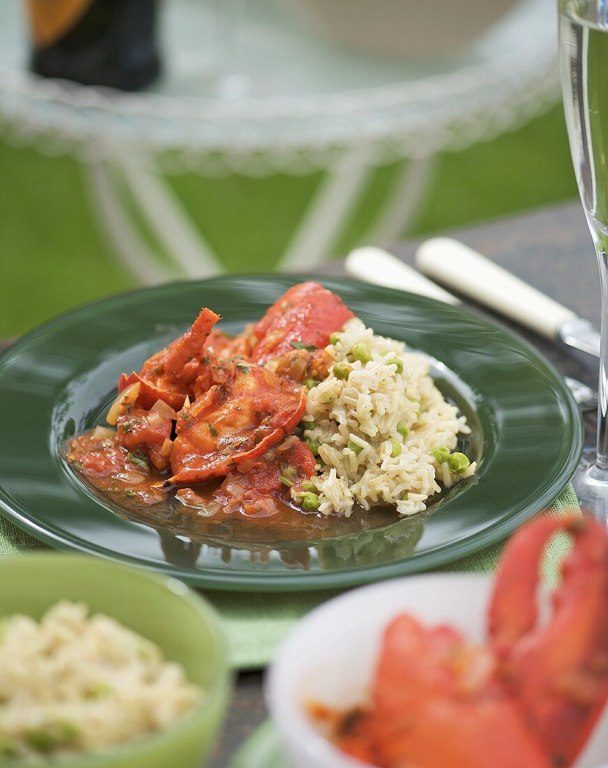 Lobster in tomato sauce with rice and peas