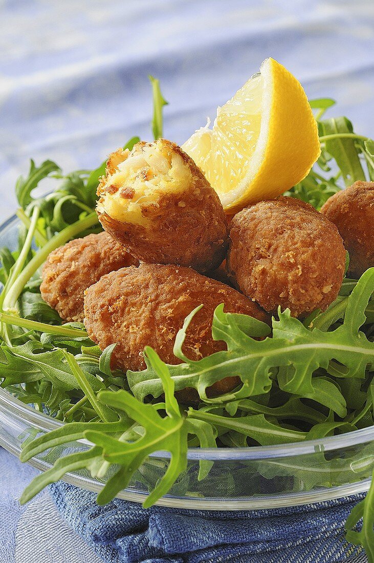 Fish and chorizo croquettes on rocket
