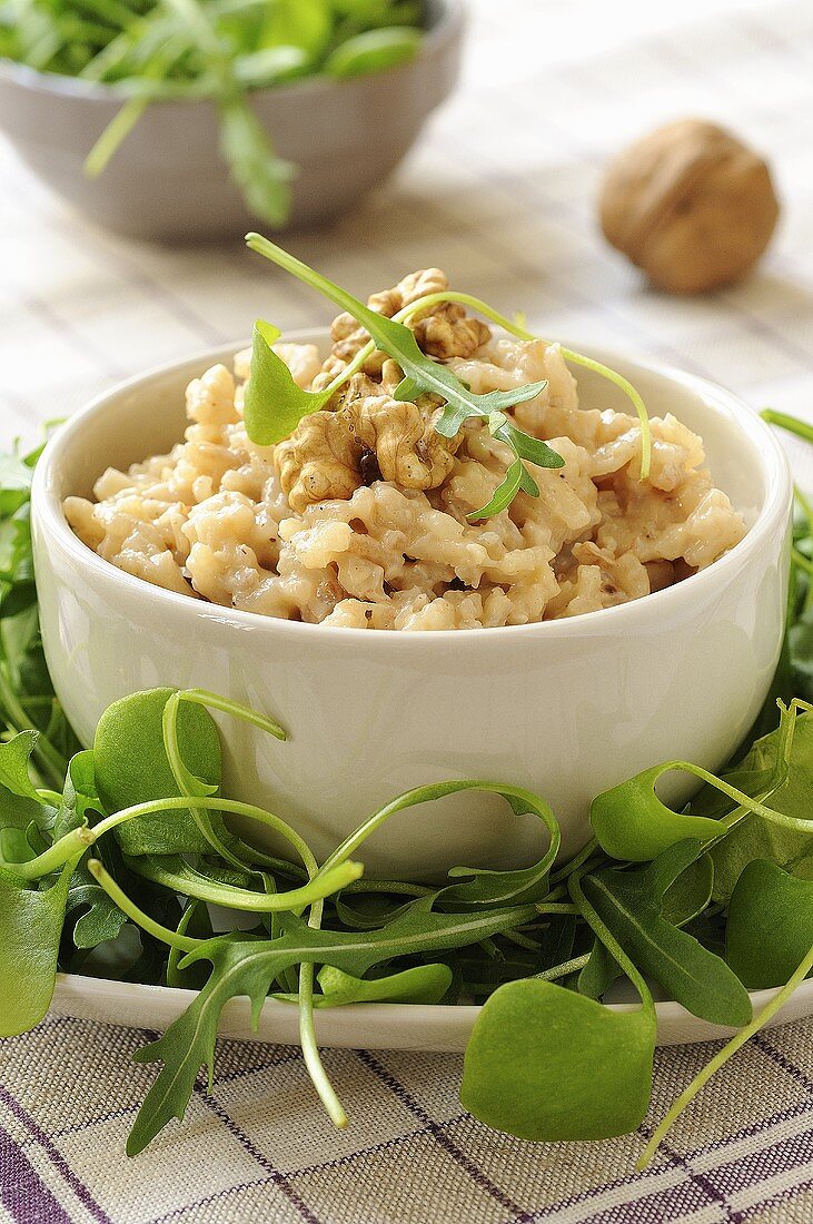 Gorgonzola risotto with walnuts in bowl on salad