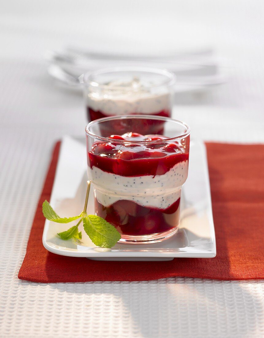 Poppy seed cream with cherries in two glasses