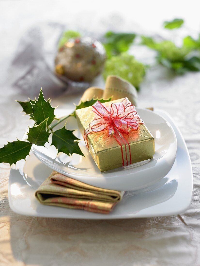 Christmas place-setting with a gift on the plate