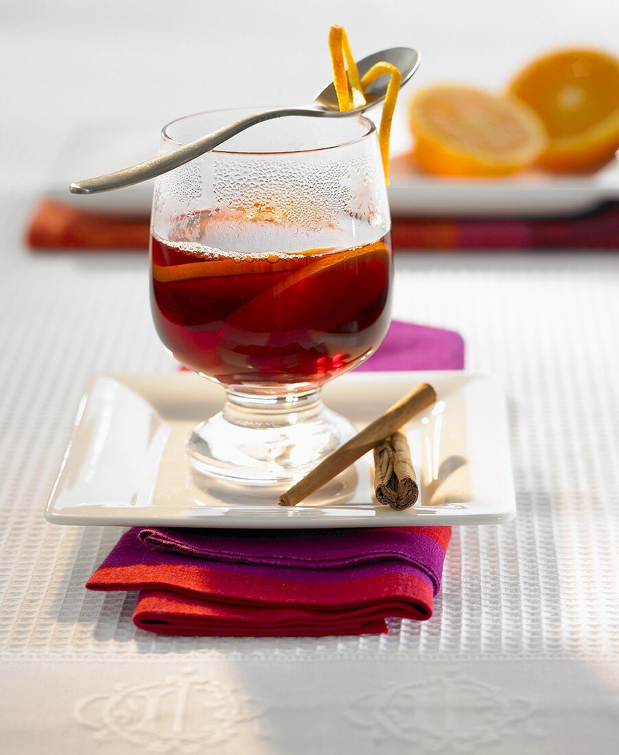 A glass of Christmas punch with orange slices