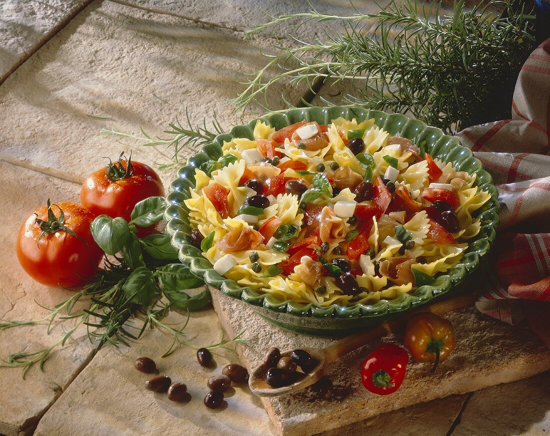 Pasta salad with ham, capers, olives, tomatoes, mozzarella