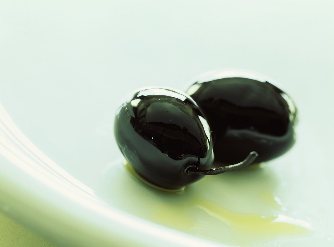 Two black olives preserved in oil