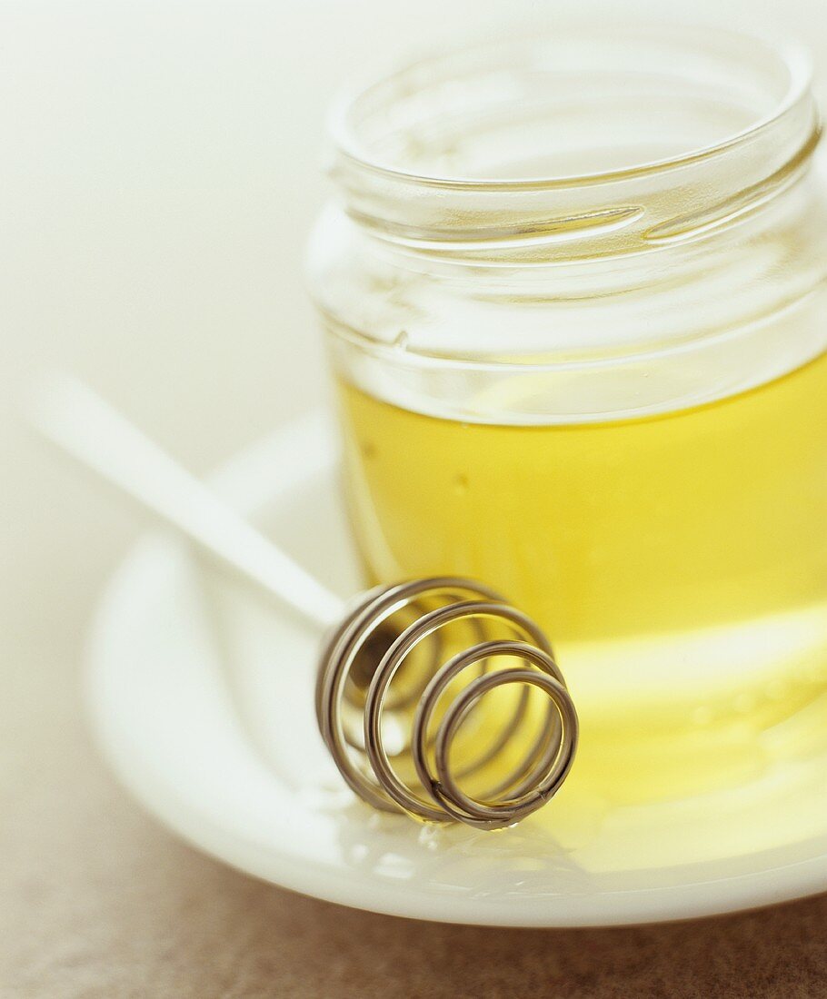 Jar of honey with a honey dipper