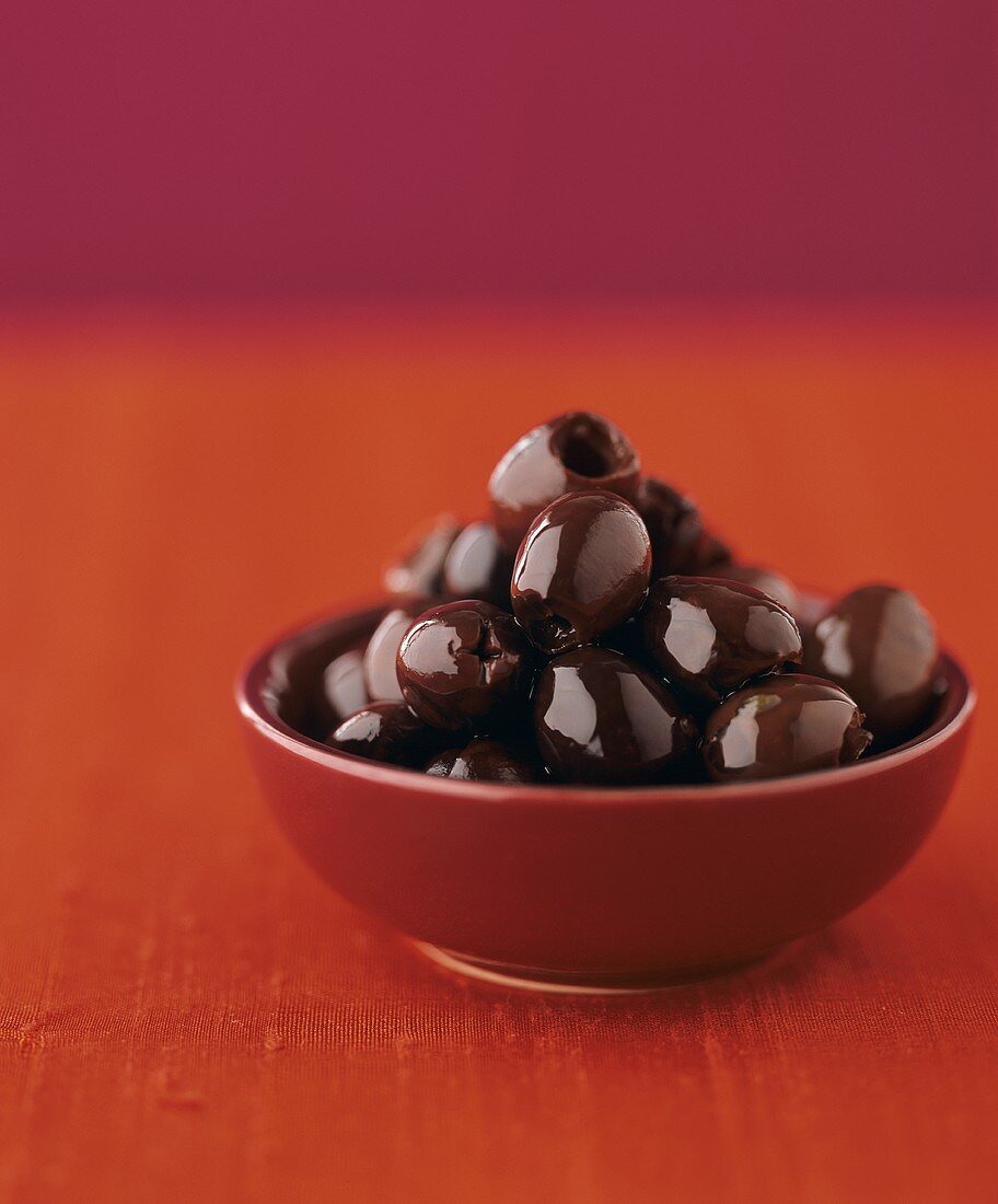 Black olives in oil in a small bowl