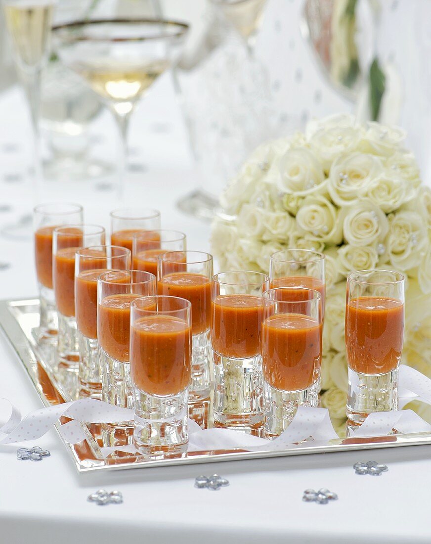 Gazpacho in glasses on a tray at a wedding reception