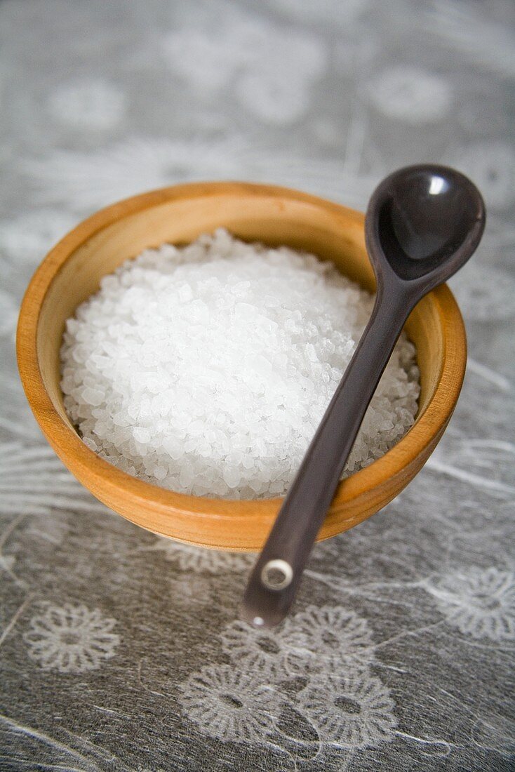 Sea salt in a small wooden bowl with a spoon