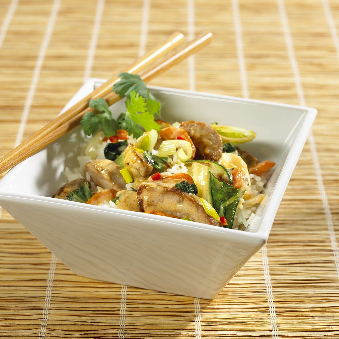 Stir-fried pork and vegetables with coconut sauce on rice
