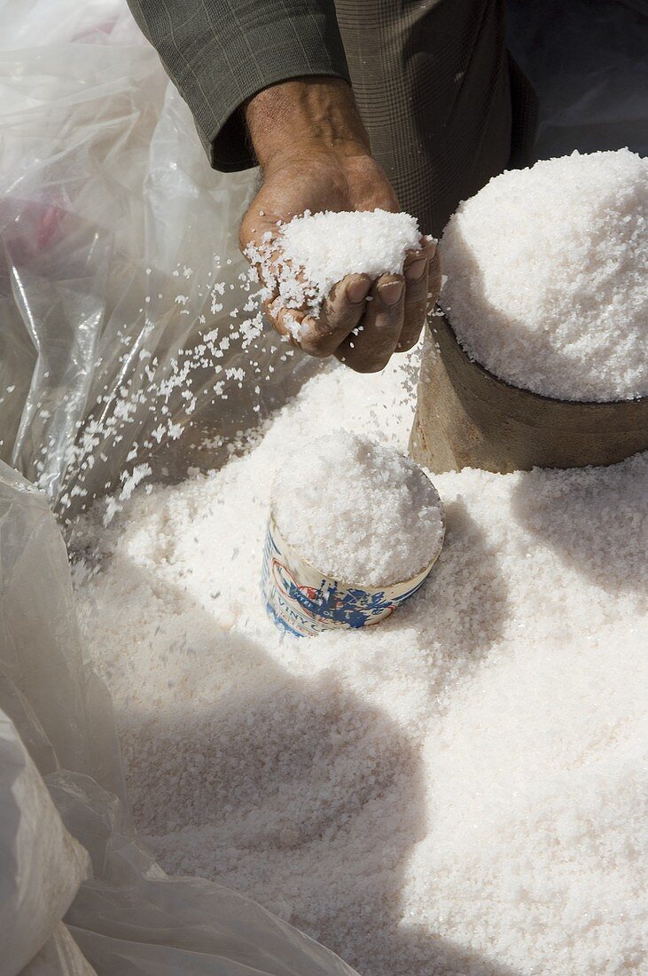 Man putting sea salt into containers