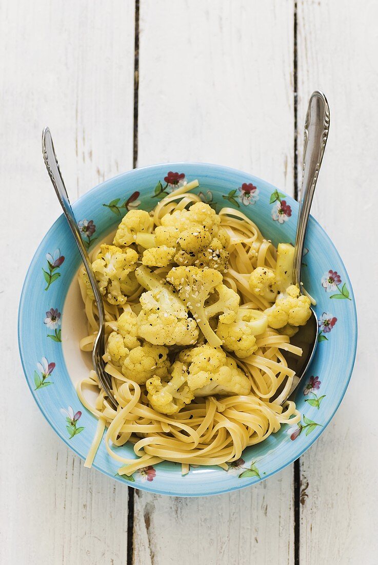 A plate of curry tagliatelle with cauliflower