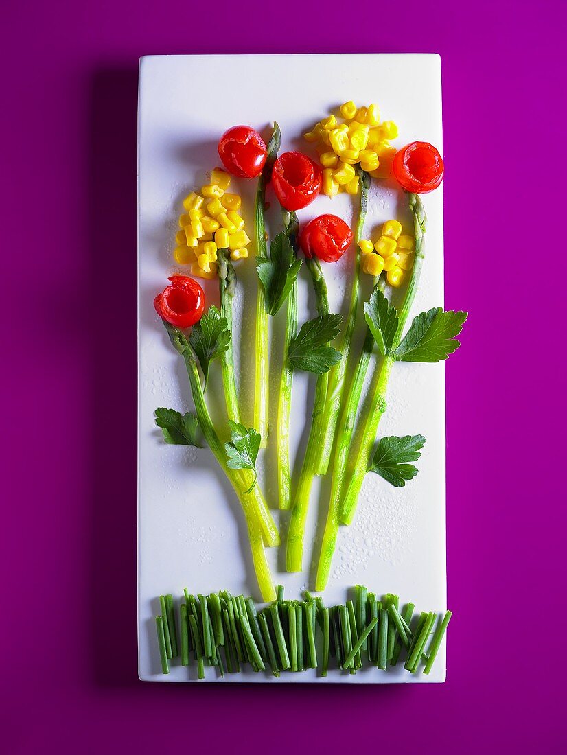 Vegetable salad arranged in the shape of flowers on a platter