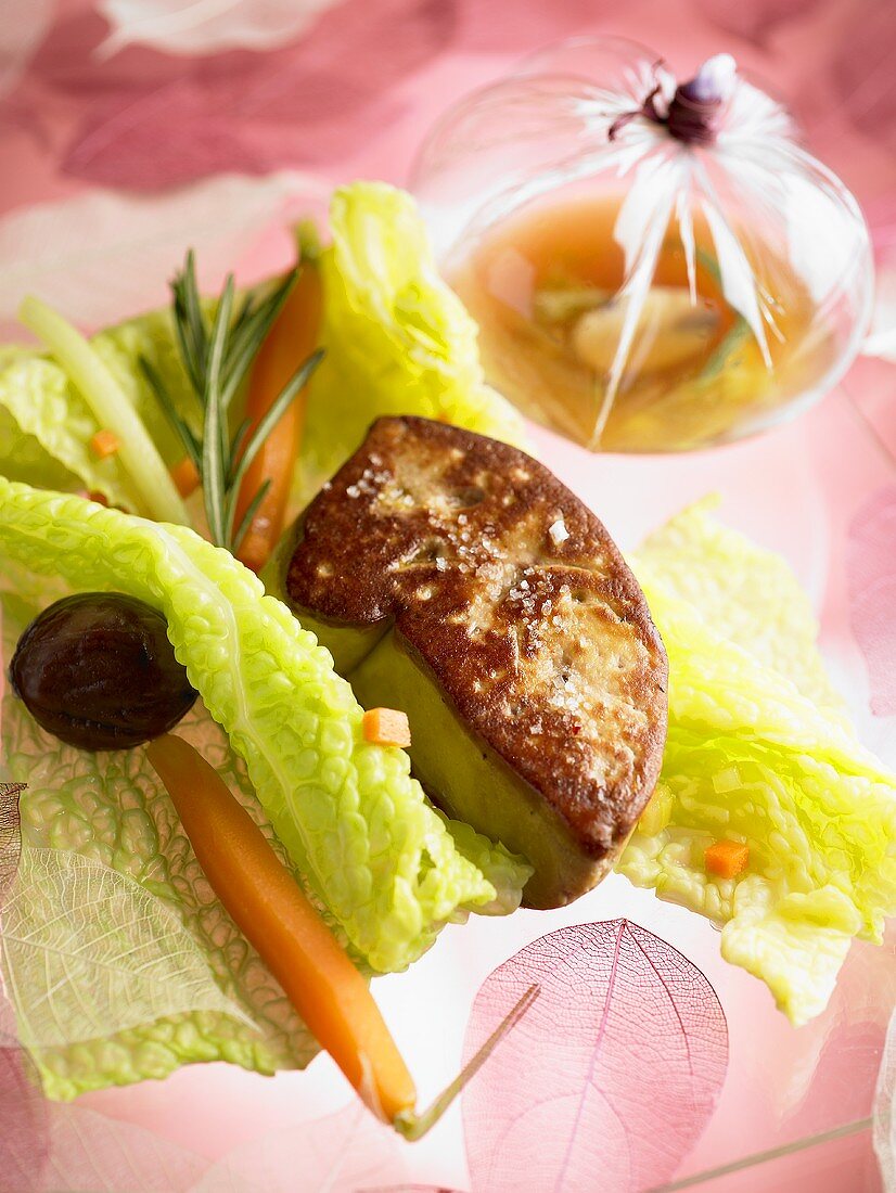 Fried goose liver on young savoy cabbage with carrots