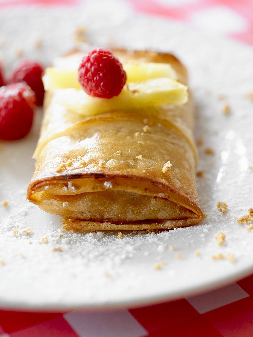 Pineapple in filo pastry with fresh raspberries